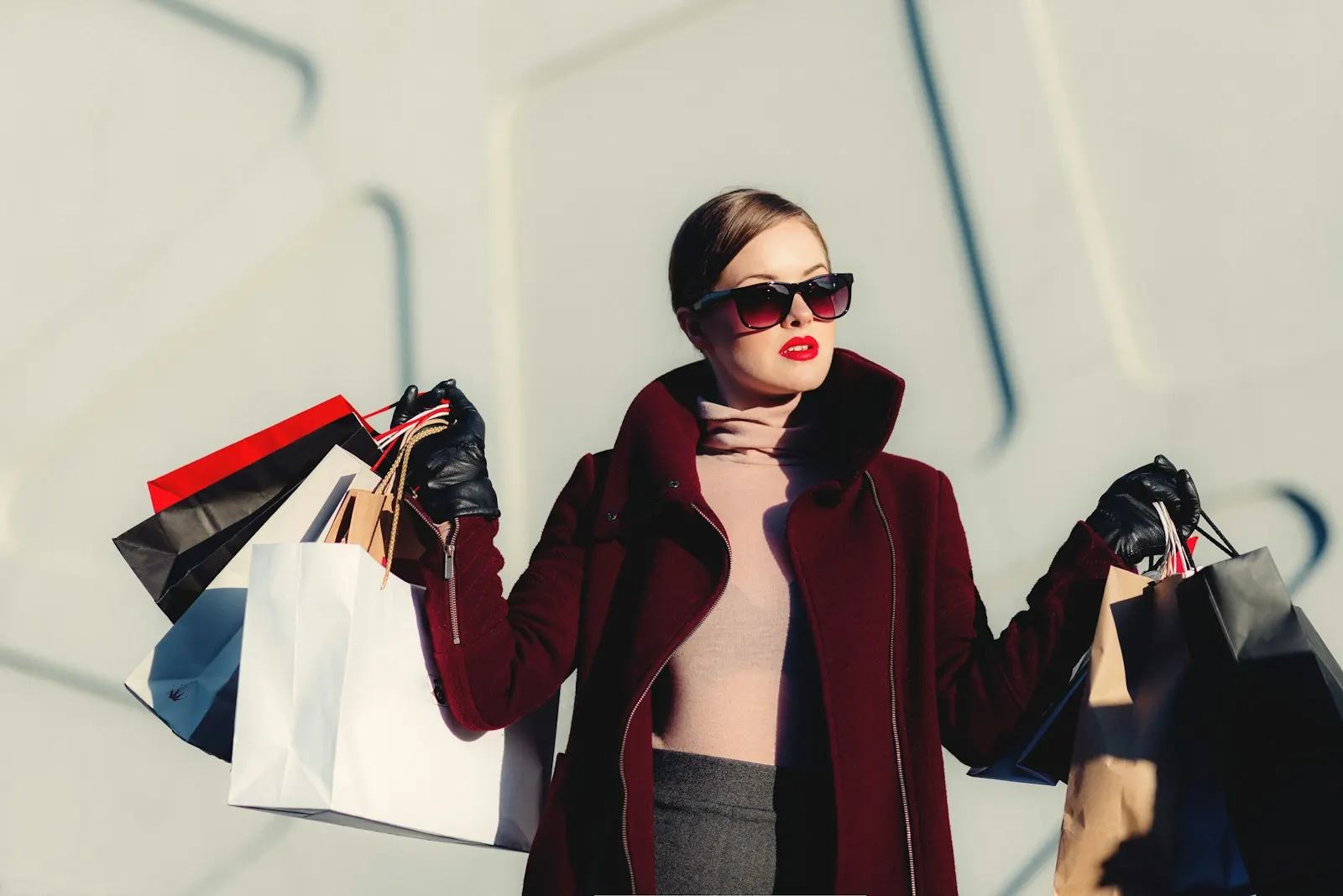 Shopper holding several shopping bags