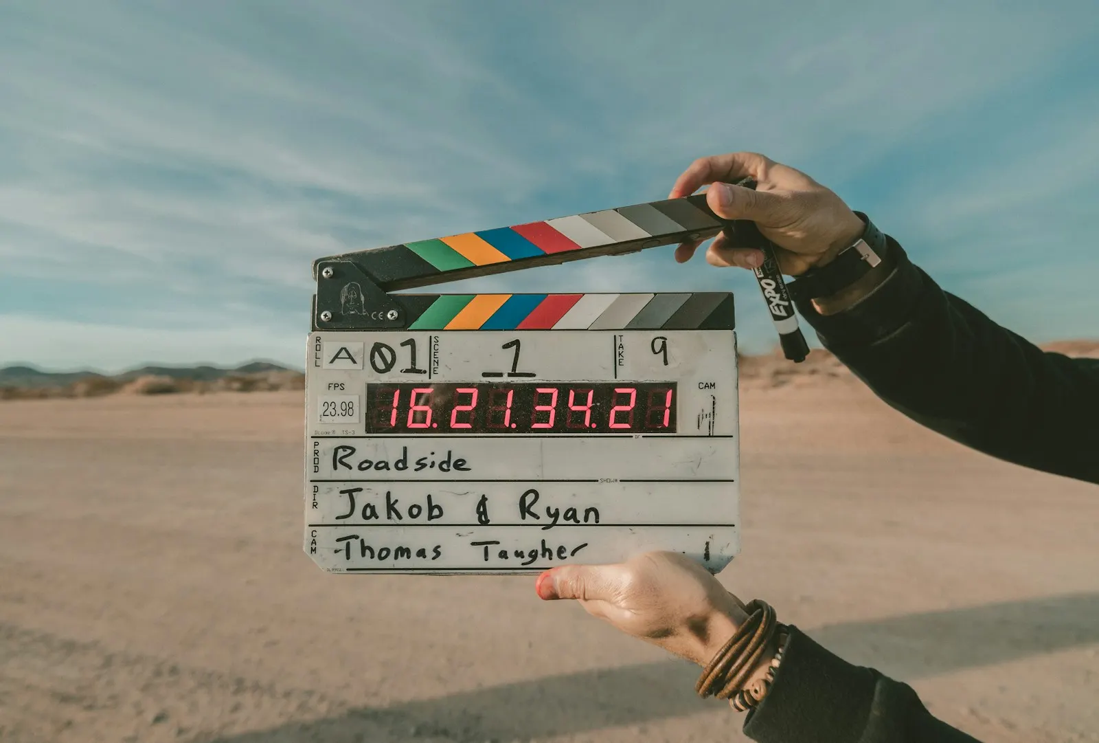 Film clapperboard held outdoors