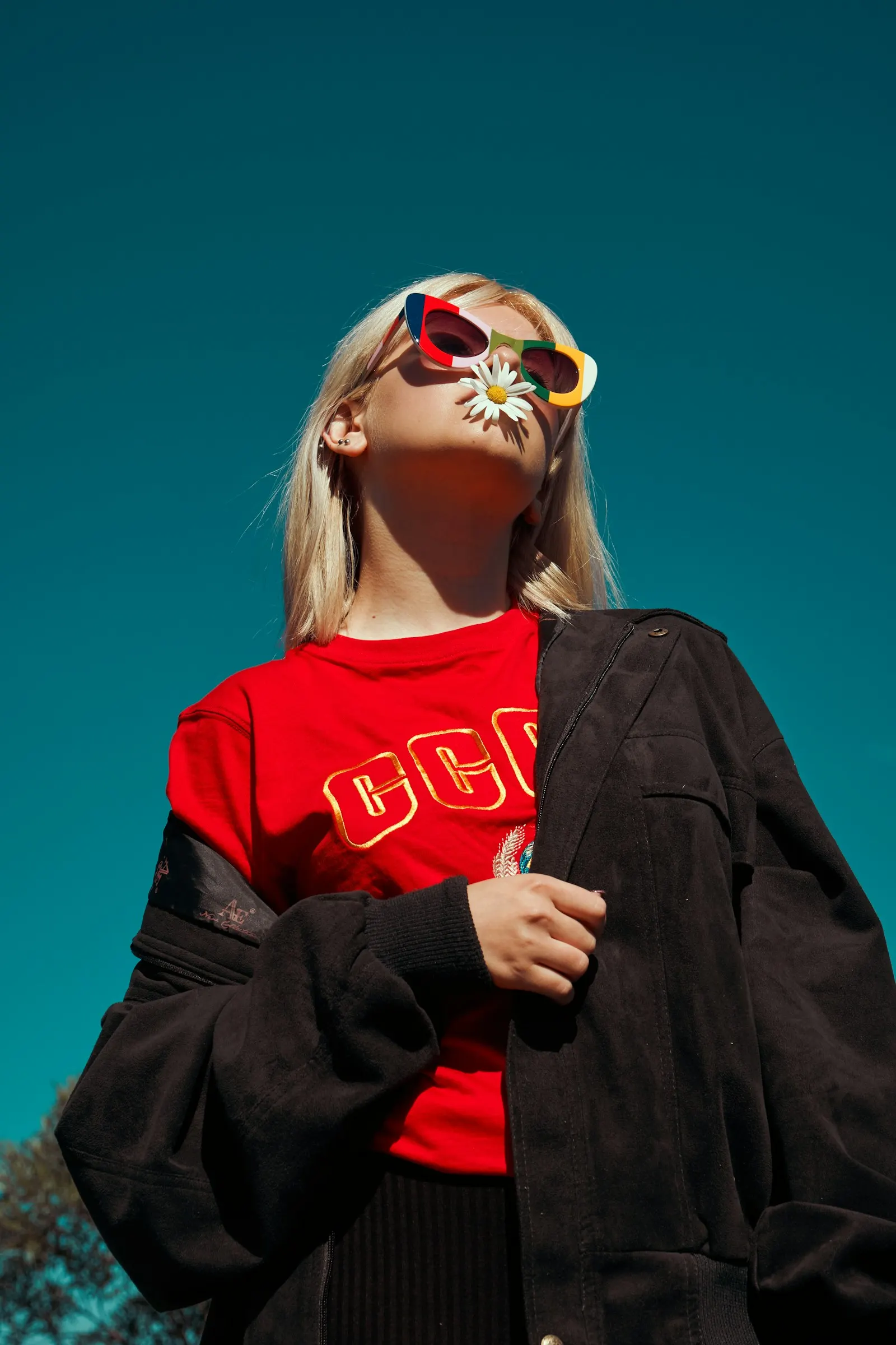 Woman wearing a red shirt and dark jacket
