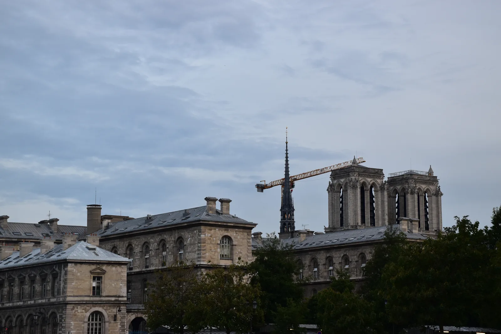 A side view of Notre-Dame de Paris with a construction crane, October 2025