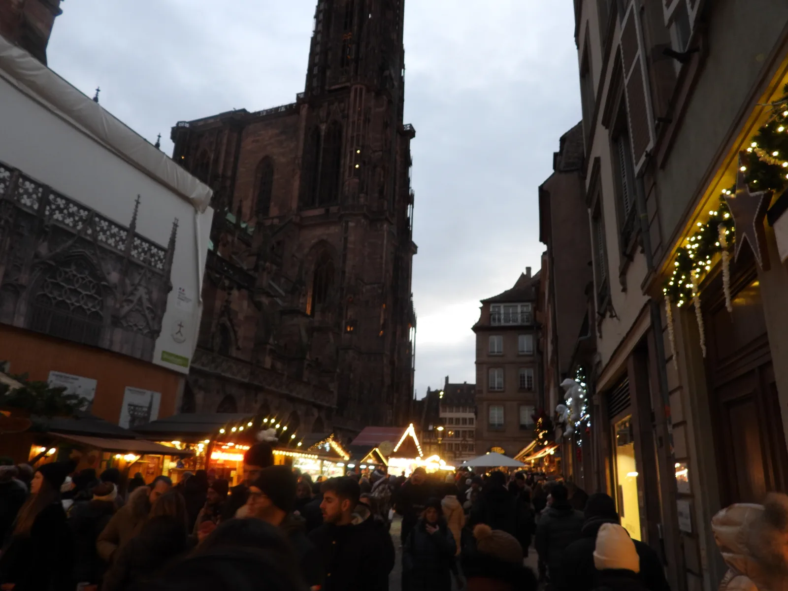 Christmas market stalls below Strasbourg Cathedral in November 2023